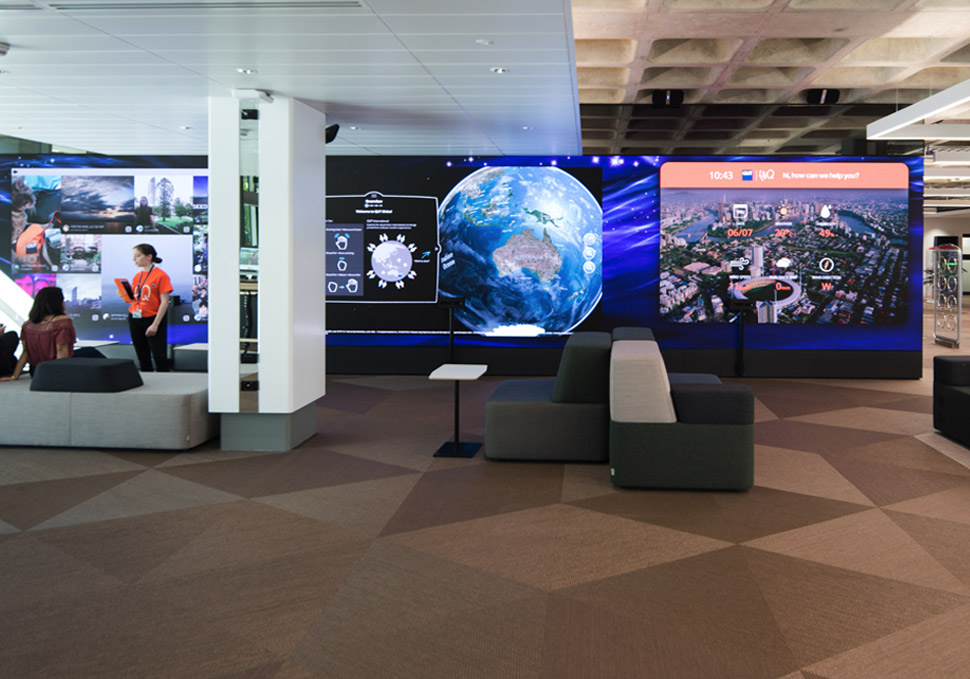 Graphic design, students in front of QUT HiQ Gardens Point LED wall with digital content by Maya Walker