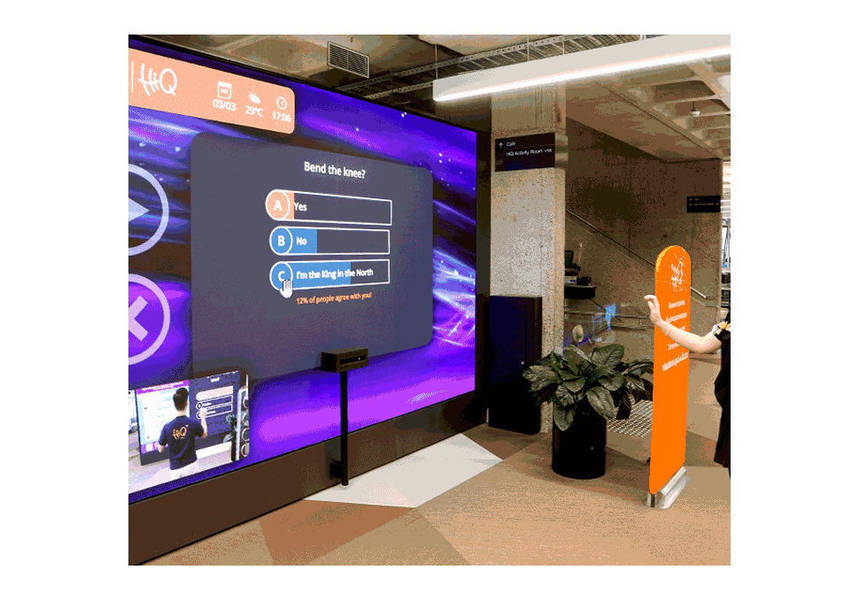Graphic design, student taking survey on large LED screen at HiQ Gardens Point QUT using Kinect cameras, with digital content by Maya Walker